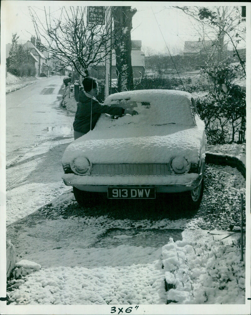 A motorist clears snow off their car in North Berkshire. - Vintage Photograph