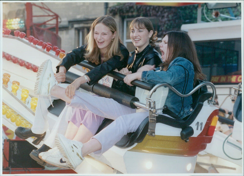 Fairgoers enjoy the attractions at St Giles Fair in Oxford, England. - Vintage Photograph