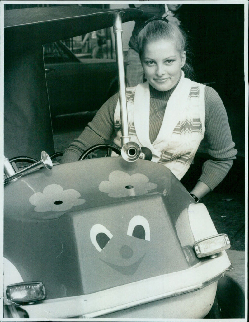 Sixteen-year-old Lesley Price sitting in a new ride called the Ladybird. - Vintage Photograph