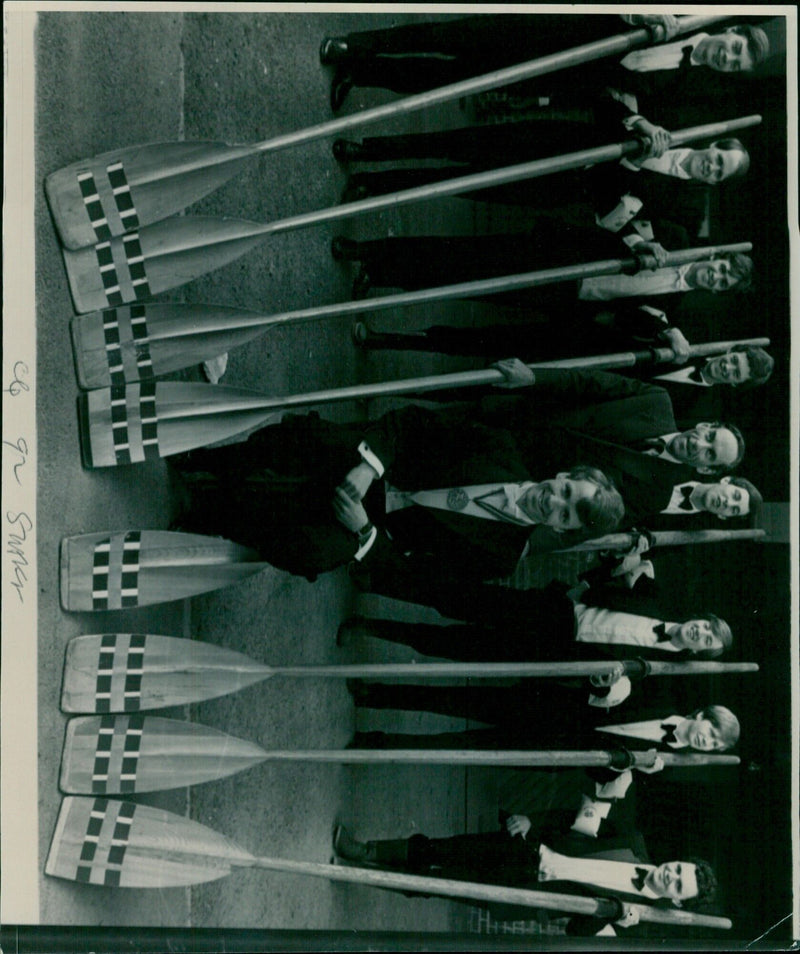 A group of staff members wearing protective face masks stand in the Suks 1-3 area. - Vintage Photograph