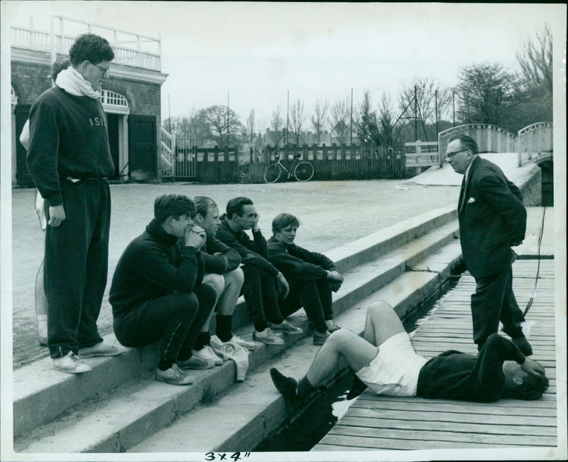 Members of the Keble College 1st VIII prepare for the University Summer Eights by resting and rafting on the Isis. - Vintage Photograph