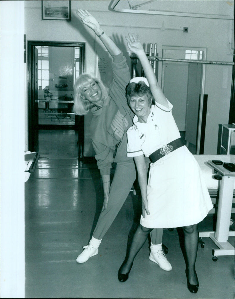 Model Diana Moran poses with S.E.N. Denis Kennedy. - Vintage Photograph