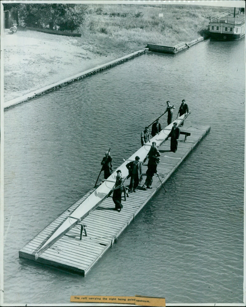 Eight people travel upstream in a raft. - Vintage Photograph