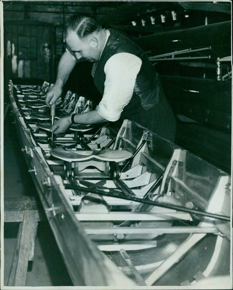 Albert Andrews, Oxford University waterman, readying a boat for the trial eights. - Vintage Photograph