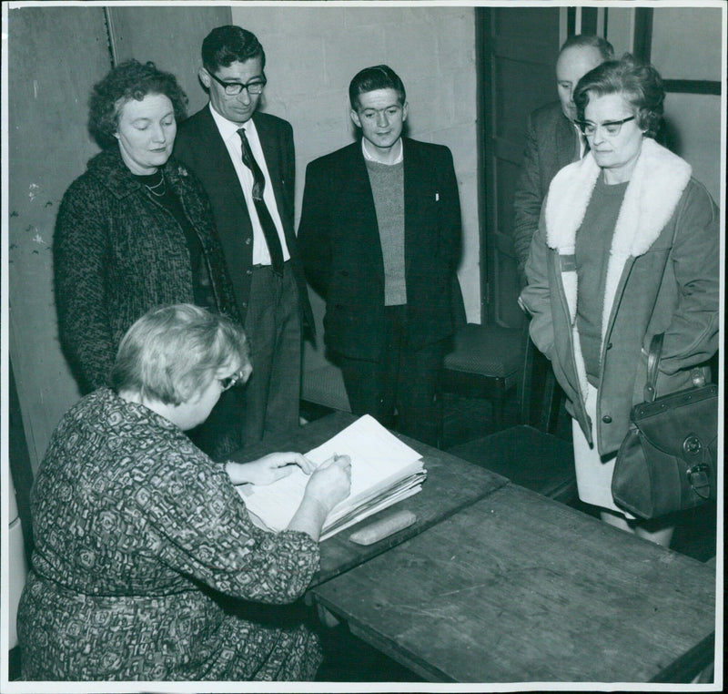 A representative from the Oxford Miss Quwen Watkins Houseing Committee speaks to people affected by the whirlwind at the Barton Community Centre. - Vintage Photograph