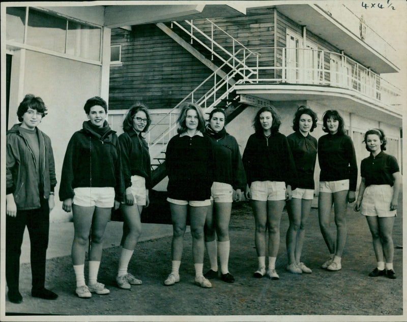 The Oxford women's crew prepares for a race against Cambridge on the river. - Vintage Photograph