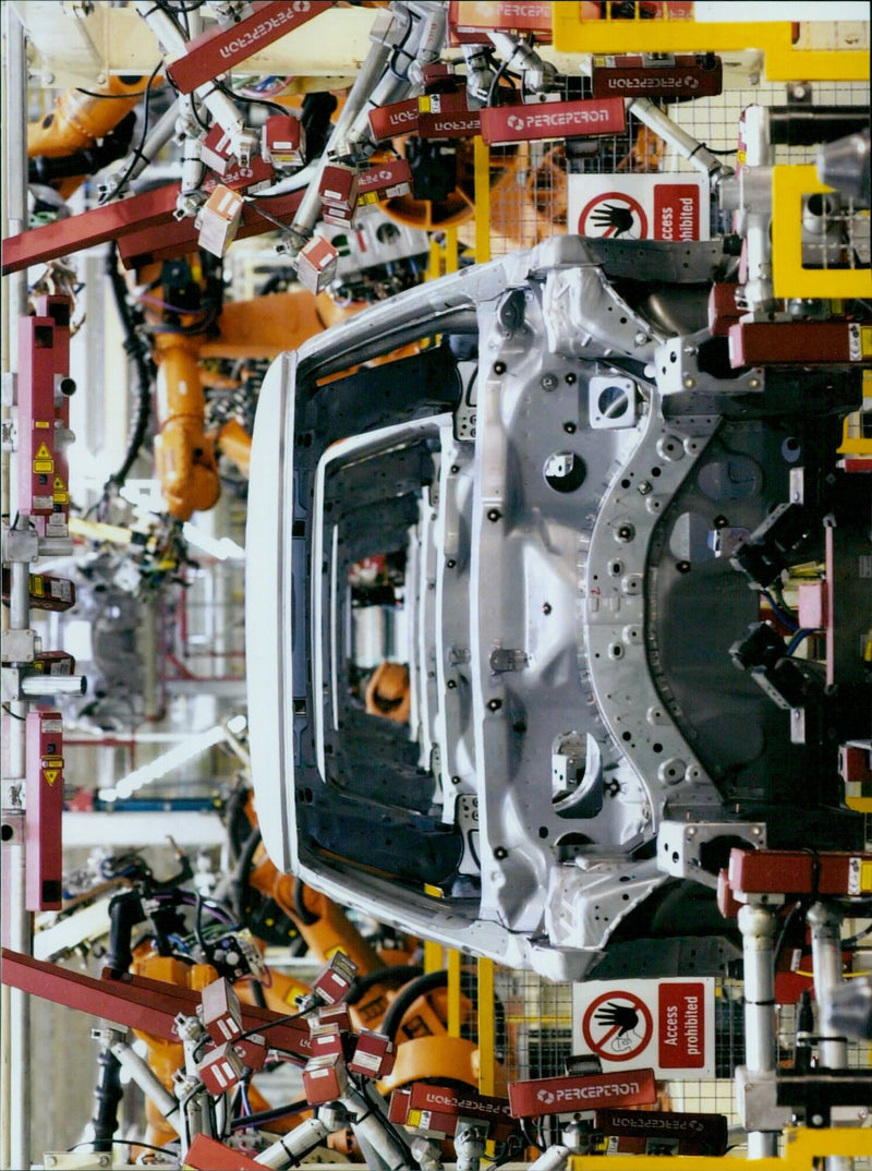 BMW Group Plant Oxford workers installing Perceptron cameras on a body in white. - Vintage Photograph