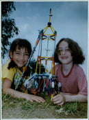 Pupils Romini Giles and Camilla Wilson, aged seven and eight respectively, pose with a model of Apollo 20 in a national engineering competition. - Vintage Photograph