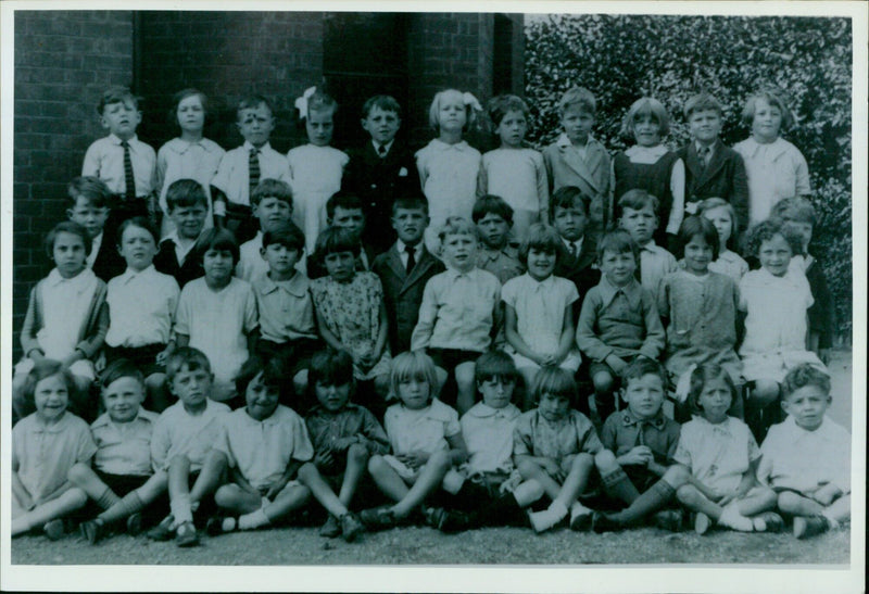 Mrs. Phyllis Bolt looks through old photos of herself from her time at Oxford schools in the 1930s. - Vintage Photograph