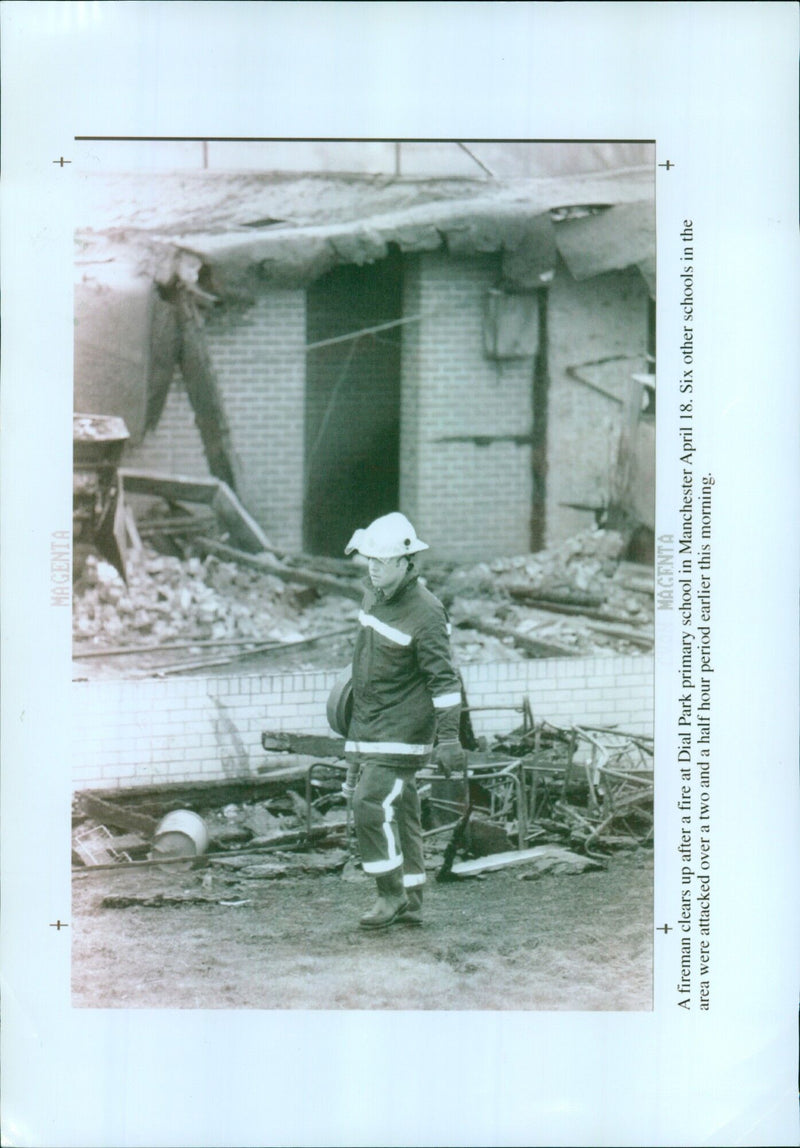 Firefighter cleans up after a fire at Dial Park Primary School in Manchester. - Vintage Photograph