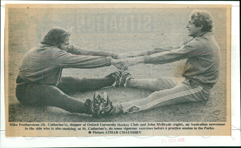 Oxford University Hockey Club members Mike Featherstone and John McBryde exercise before a practice session. - Vintage Photograph