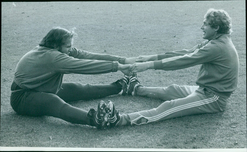 Oxford University Hockey Club members Mike Featherstone and John McBryde exercise before a practice session. - Vintage Photograph