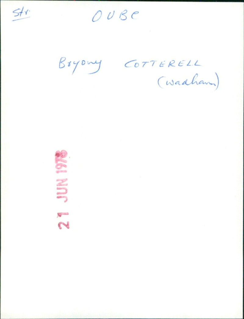 A young woman walking along a street in the city of Cotterell. - Vintage Photograph