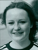 A young woman walking along a street in the city of Cotterell. - Vintage Photograph