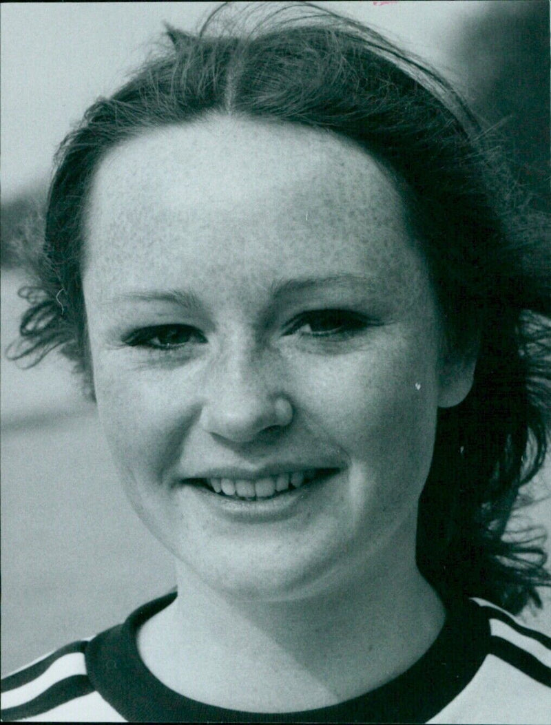 A young woman walking along a street in the city of Cotterell. - Vintage Photograph