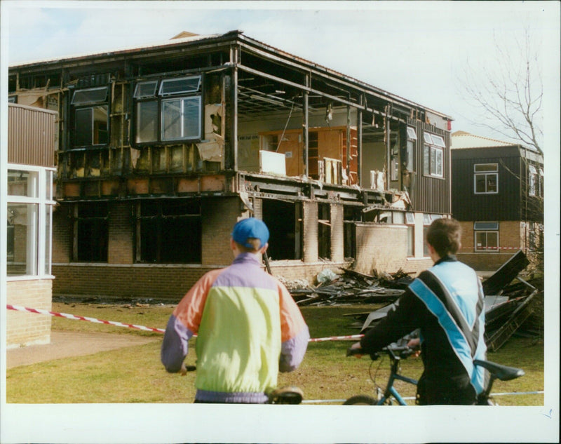 Students Anthony Giles (left) and Neil Gough survey the damage of a fire at Carterton Community College in Oxfordshire, UK. - Vintage Photograph