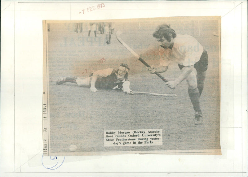 Bobby Morgan of the Hockey Association rounds Oxford University's Mike Featherstone during a game in the Parks. - Vintage Photograph