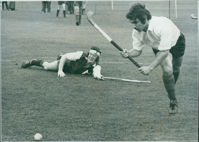 Bobby Morgan of the Hockey Association rounds Oxford University's Mike Featherstone during a game in the Parks. - Vintage Photograph