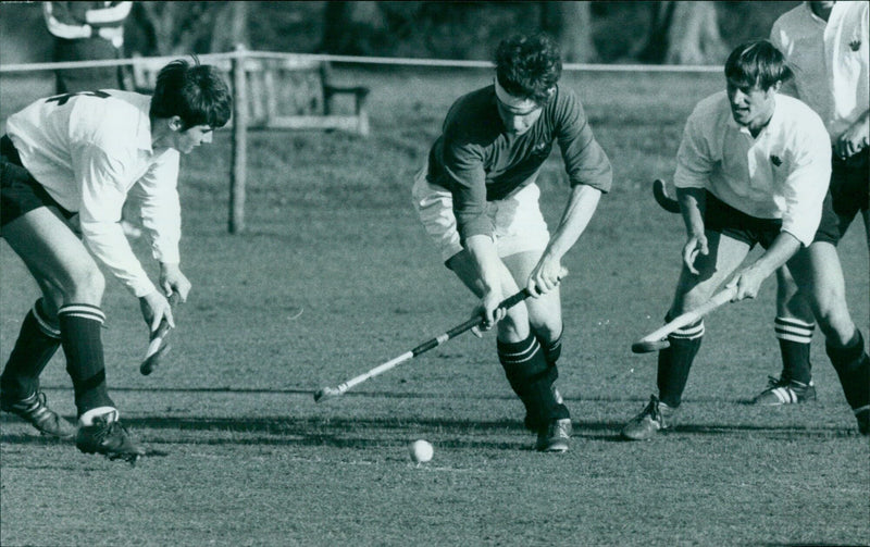 Oxford University's G. J. Ebbutt dribbles past Royal Navy defenders C. Davison (left) and D. Worrall. - Vintage Photograph