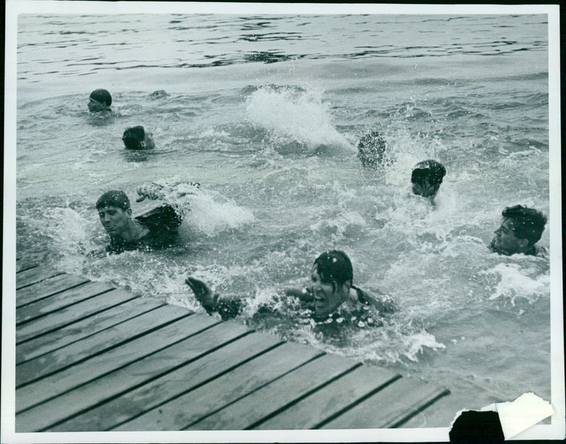 Members of the NOC 8 rowing team celebrating their victory in the final race. - Vintage Photograph