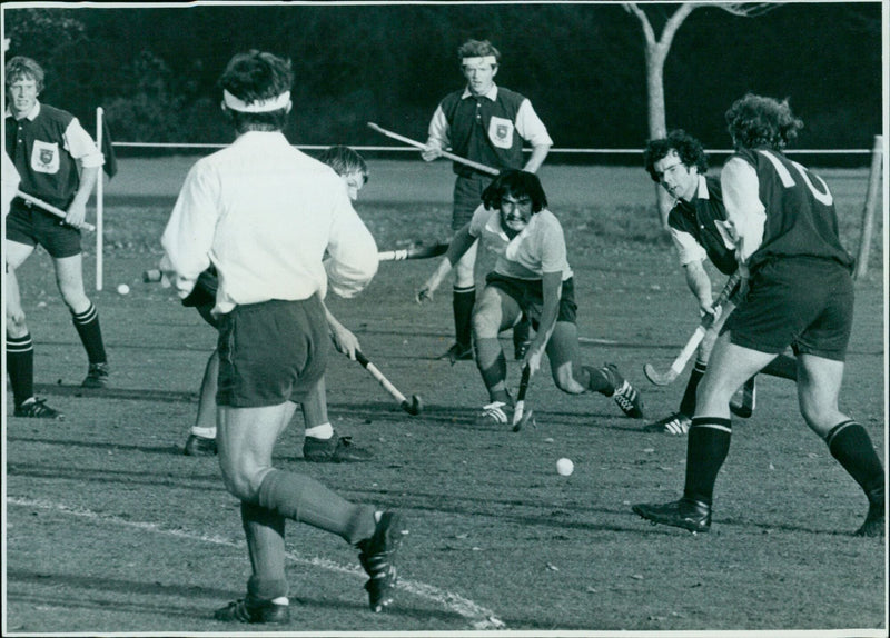 Selwyn Maister of the University passes to John Roberts, while Angus Bogdon of the Hockey Association attempts to tackle. - Vintage Photograph