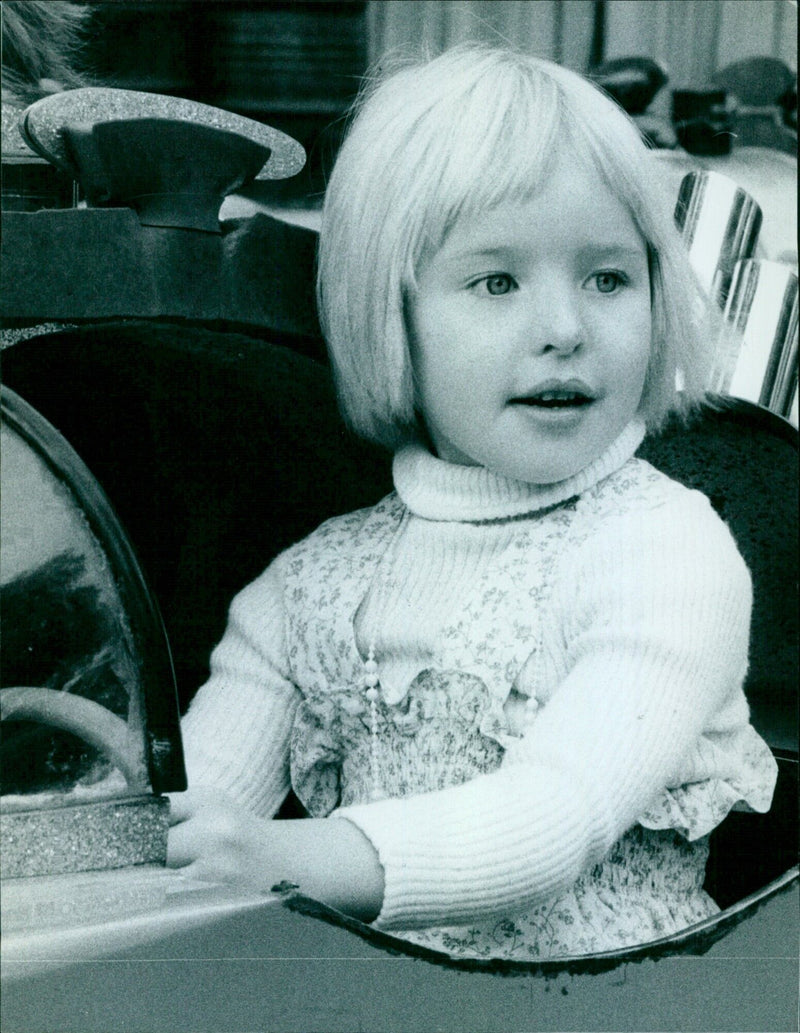 Five-year-old Hannah Watson rides a mini-car at St Giles Fair. - Vintage Photograph