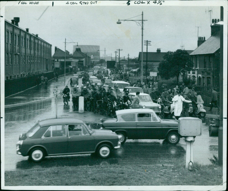 A group of seven people walking together on the street. - Vintage Photograph