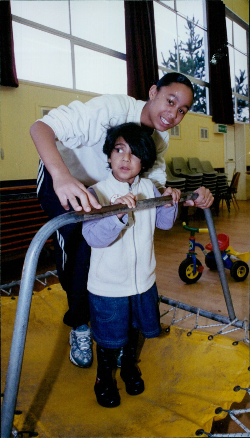 Simone Ferreira, a Bayswater pupil, and Saima Iqbal enjoy a trampoline at the Oxford Assault Course. - Vintage Photograph