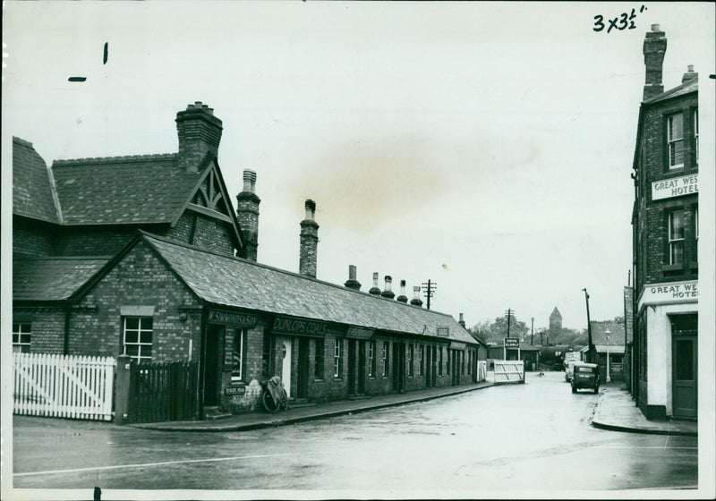 Cars and pedestrians pass the Great Western Hotel in Oxford, England. - Vintage Photograph