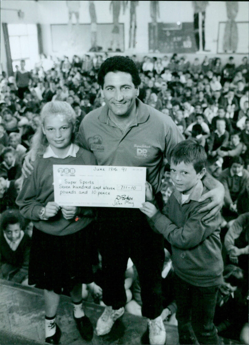 Brian Hooper, a pole vaulter from Bayswater School, receives a cheque from Lucy Stoke and Keiran Ellis. - Vintage Photograph