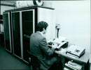 A man receives a call at a hotline center in the United Kingdom. - Vintage Photograph