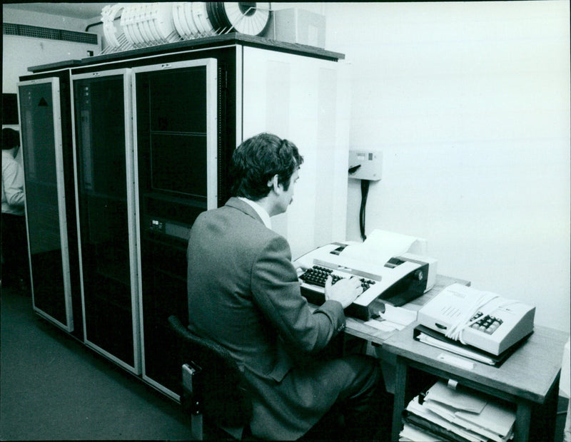 A man receives a call at a hotline center in the United Kingdom. - Vintage Photograph