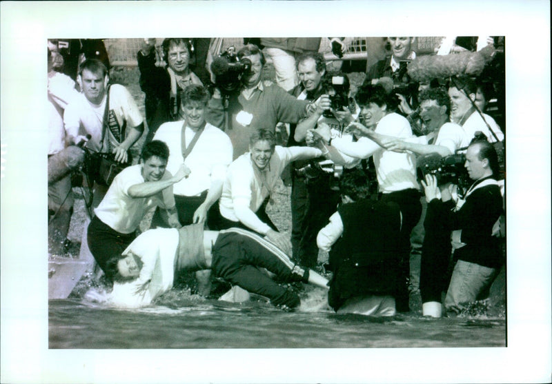 Cambridge team celebrates victory at Oxford University rowing boat race. - Vintage Photograph