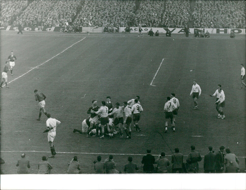 Players from the CACHO 8 CHAN PM 620 team compete in a rugby match. - Vintage Photograph