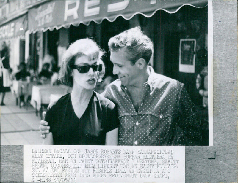 Actors Lauren Bacall and James Robarts are photographed in Mentone, as speculation of a potential wedding swirls. The only obstacle to their union is Robarts' uncertainly over the legal status of his divorce from his previous wife. - Vintage Photograph