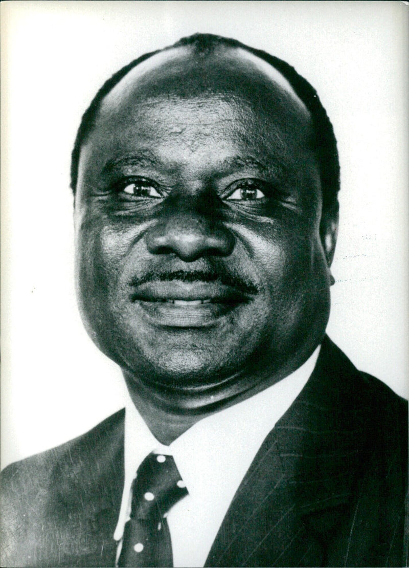 Zimbabwe's Minister of Finance, Enos Mikala, attends a press conference in London in 1980. - Vintage Photograph