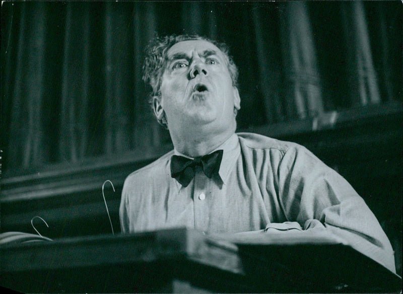 Dr. Karl Rankl, renowned conductor of the Vienna Volsoper, Berlin State Opera, and Royal Opera House, Covent Garden, leads a rehearsal. - Vintage Photograph