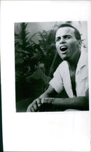 Two people are seen speaking with one another while wearing masks as a precaution against the spread of COVID-19. - Vintage Photograph