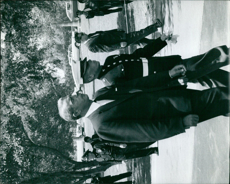 On August 3, 1962, a group of mourners pay their respects at a graveside service in Torsgåt, Sweden. - Vintage Photograph