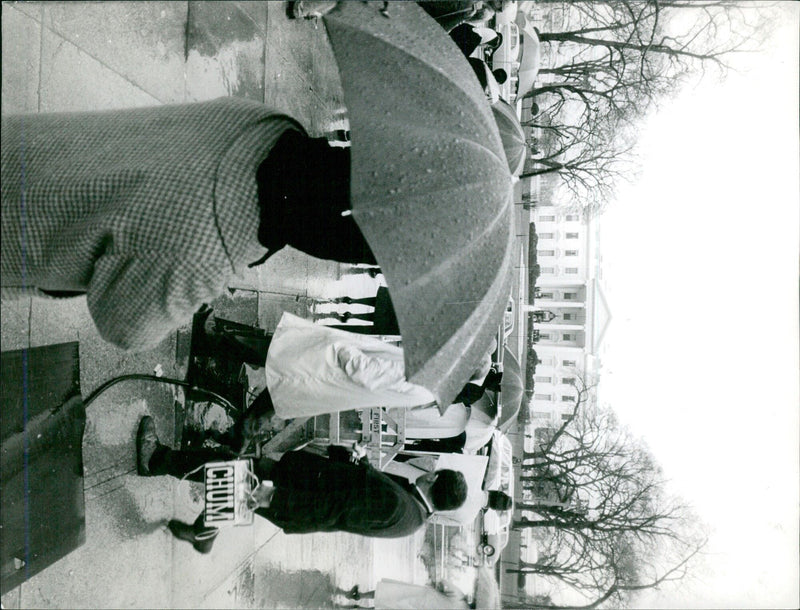 A woman wearing a protective face mask stands in front of a mural of a soldier in uniform in Madrid, Spain. - Vintage Photograph