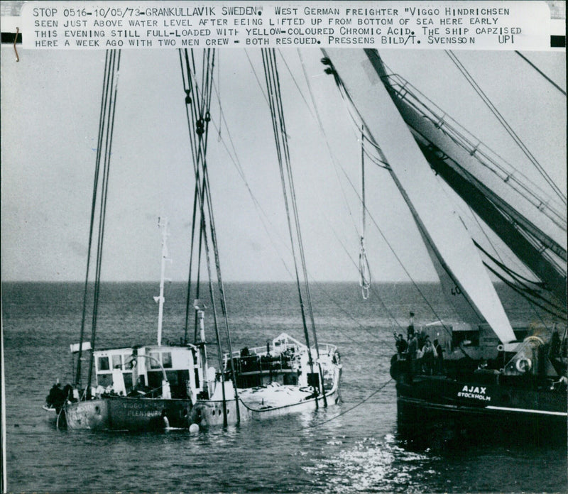 The West German freighter "Viggo Hindrichen" is seen just above the surface of the sea after being lifted from the bottom in Grankullavik, Sweden. The ship capsized with two crew members a week ago, both of whom were rescued. - Vintage Photograph