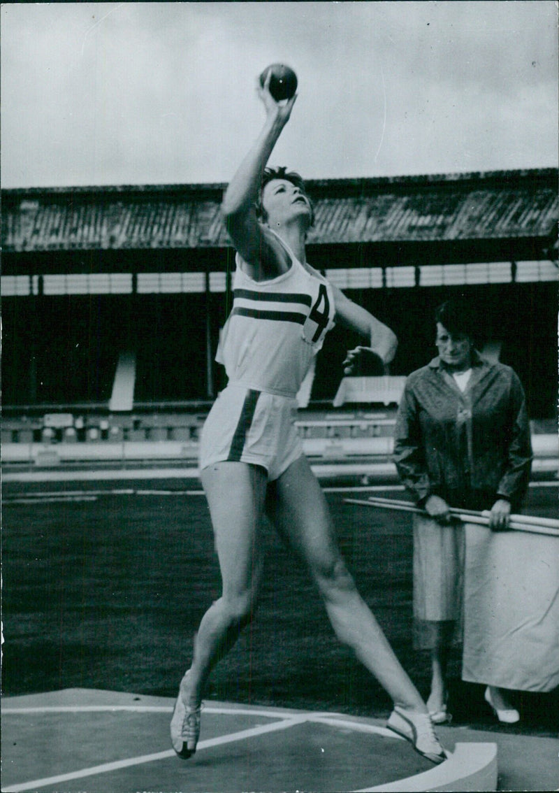 Mrs. Mary Rand, British athlete and wife of sculler Sidney Rand, poses for the camera at an international athletics event in London. - Vintage Photograph