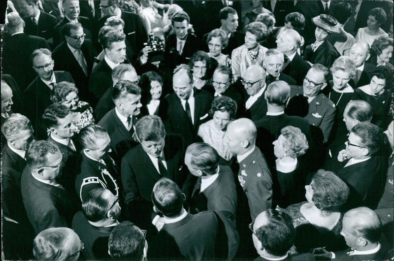 A group of people gather in front of a monument, paying homage to the victims of a recent tragedy in France. - Vintage Photograph