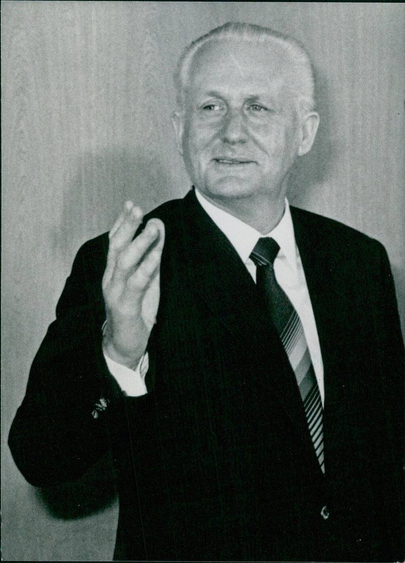 Günter Mittag, a long-time East German politician and member of the SED party, stands outside the East German Parliament in 1985. - Vintage Photograph