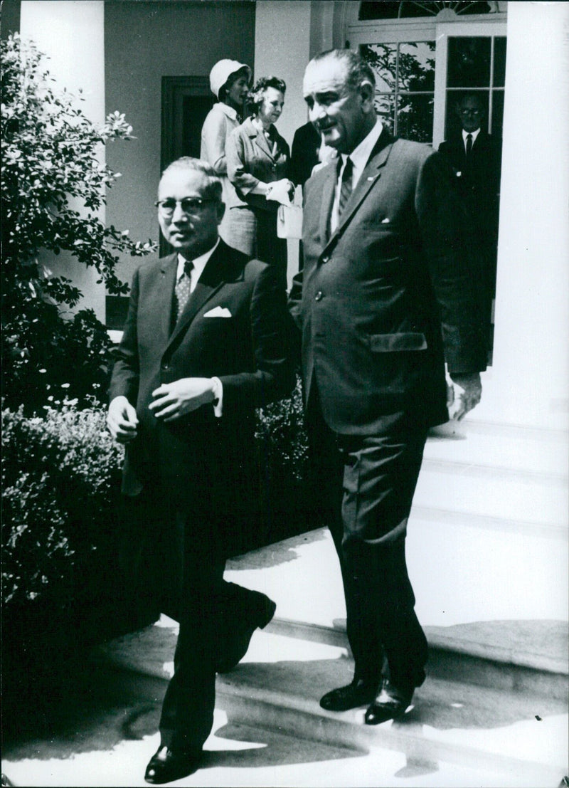 President Lyndon Johnson shakes hands with U Thant, Secretary-General of the United Nations, during a meeting at the White House in Washington, DC. - Vintage Photograph