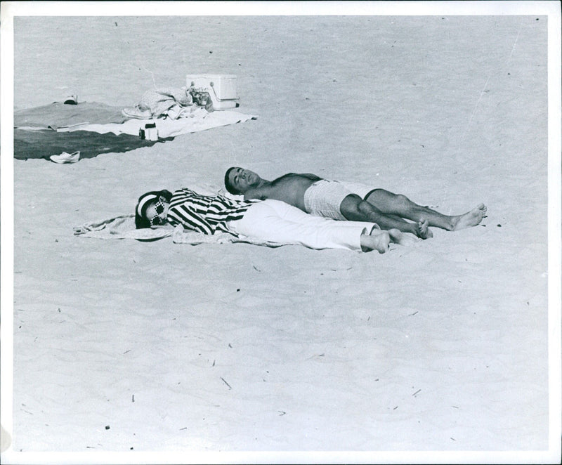 Lynda Bird Johnson and her fiancé, Marine Captain Charles Robb, spend the Labor Day weekend in Rehoboth Beach, Delaware. - Vintage Photograph