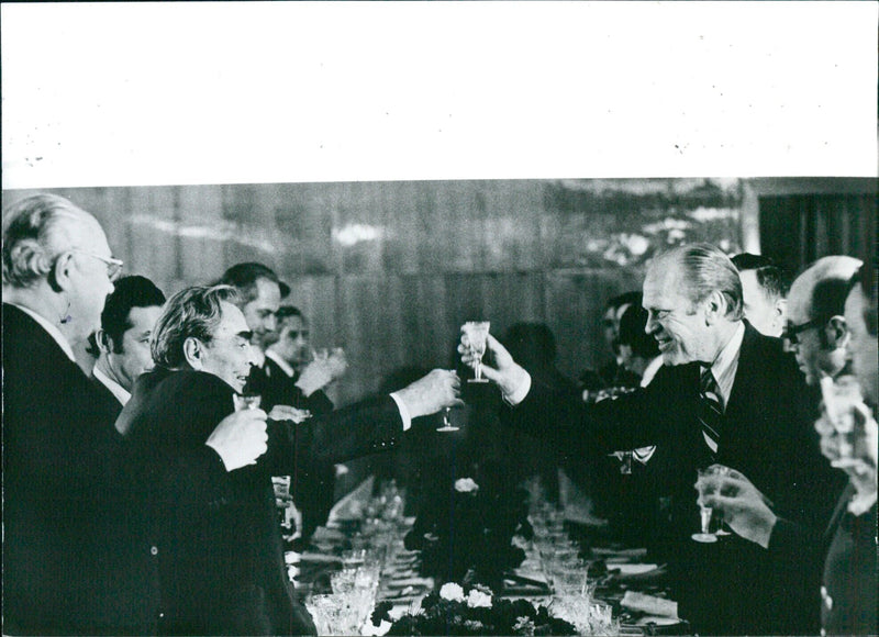 Soviet leader Laonid Brezhnev and U.S. President Gerald Ford toast each other during a dinner in Vladivostok marking the end of SALT talks. - Vintage Photograph