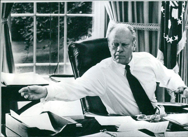 President Gerald R. Ford of the United States is seen working in shirt sleeves in the Oval Office of the White House. Photo by David H. Kennerly/Camera Press/Getty Images. - Vintage Photograph