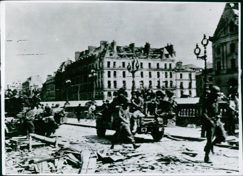 American troops speed through Rennes, Brittany in 1944 during their campaign to liberate the region. - Vintage Photograph