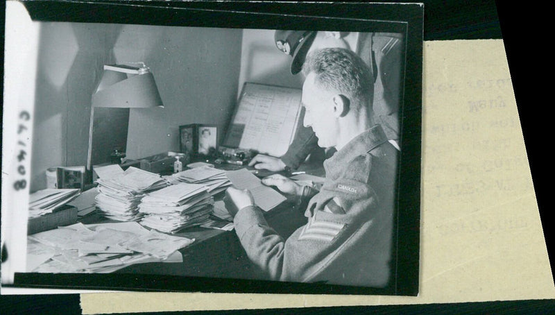 Canadian Sergeant E.R. Seran and an officer examine German mail that was dropped in Canadian lines during the evacuation of Dunkirk in October 1944. - Vintage Photograph